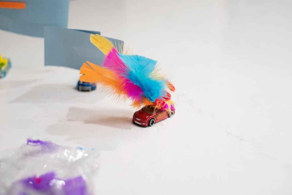 wind powered toy car with sail made from feathers