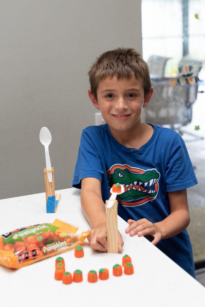 my son showing off his candy pumpkin catapult