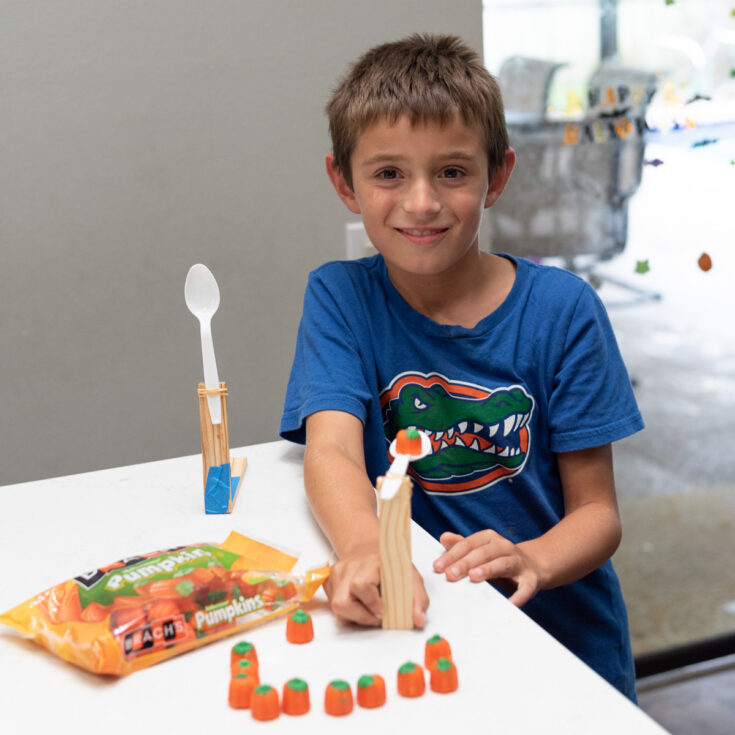 my son with his candy pumpkin catapult